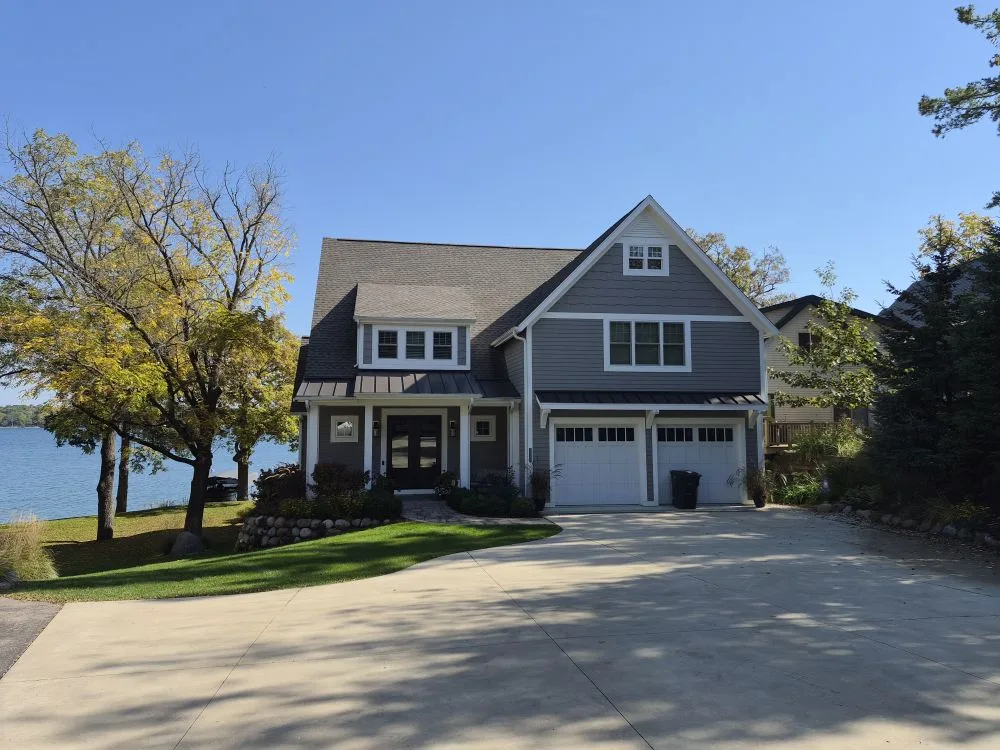 Two-story lakefront home with gray lap siding and white trim